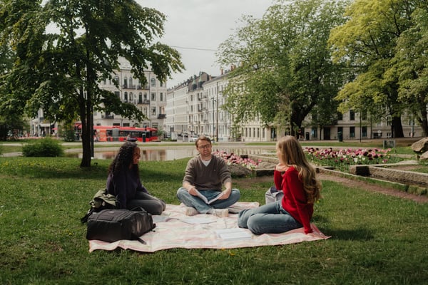 Friends lounging in the park in front of City Hall