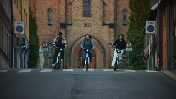 Three friends riding electric city bikes