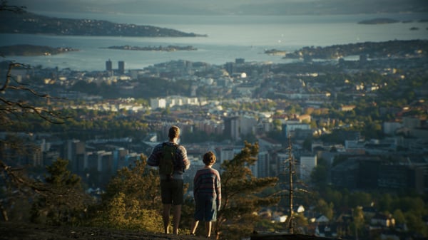 Father and son overlooking the city Of Oslo from Grefsenkollen view point 