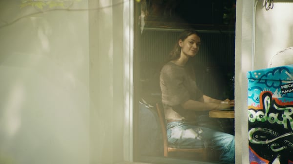 Woman looking out a cafe window