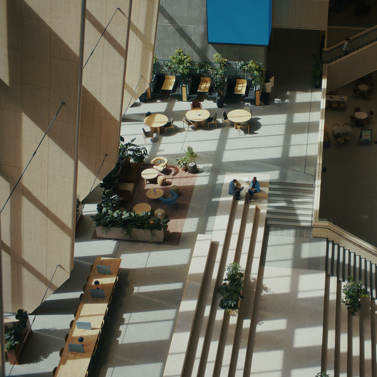 An atrium with terraced seating where people are working