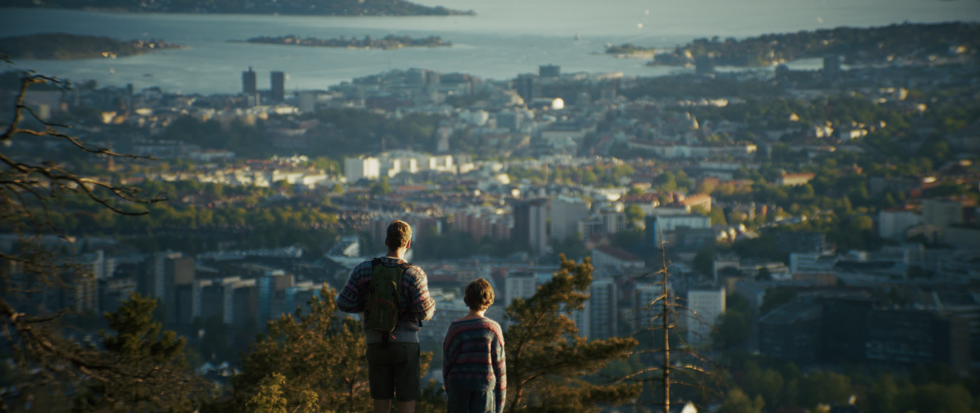Two people looking out over Oslo at dusk